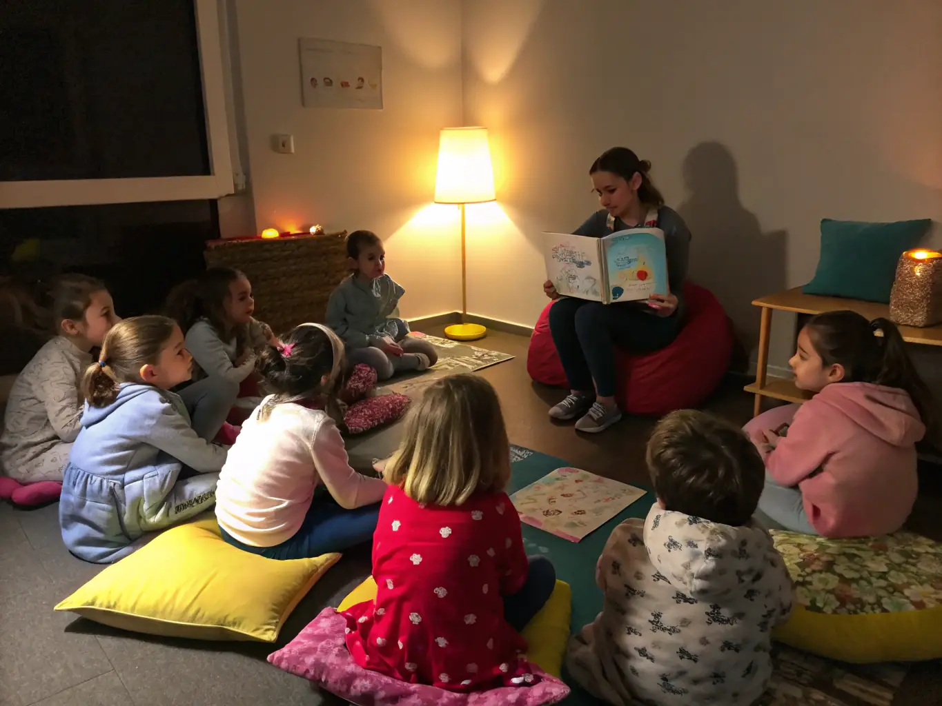 A group of children sitting in a circle, listening attentively to a librarian reading a storybook during a children's reading program at the Chierry Plaisir de Lire library.